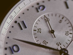 A closeup of a clock showing seconds