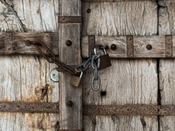 A door locked with a padlock and chain