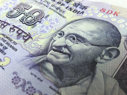 A INR paper bill with Gandhi