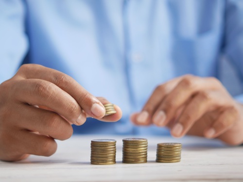 A pair of hands and some coins