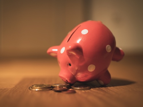 A piggy bank and some coins